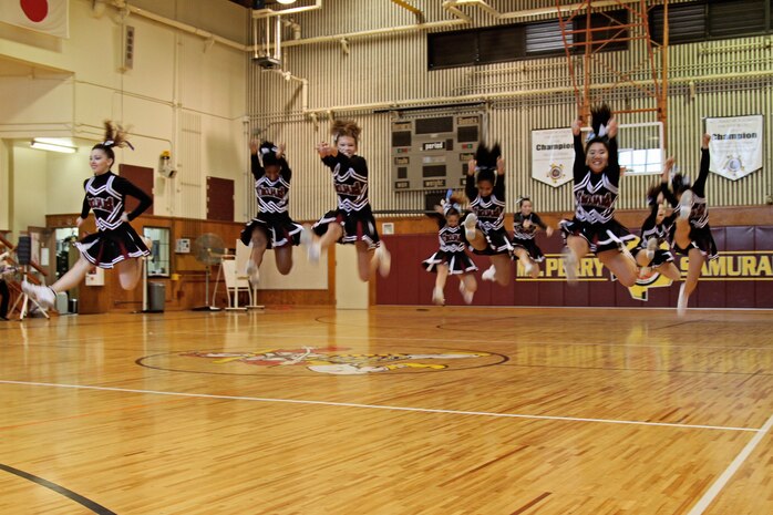 The Zama Trojans perform their team routine during the final competition of the National Cheerleading Association cheerleading clinic held at the Matthew C. Perry High School gymnasium here Nov. 12. The Trojans took 3rd place in the Department of Defense Dependents Schools-Pacific and Domestic Dependent Elementary and Secondary Schools-Guam small-school division.