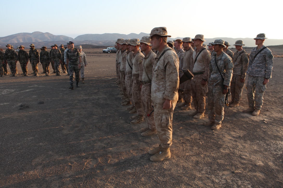 Marines with Company I, Battalion Landing Team 3/8, 26th Marine Expeditionary Unit, stand in formation along with French and U.S. National Guard troops as commanding personnel review the troops during the Desert Survival Course graduation ceremony in Djibouti, Nov. 14, 2010. Elements of 26th MEU conducted sustainment training for their current deployment at Camp Lemonnier, Djibouti, and surrounding areas.  ::r::::n::