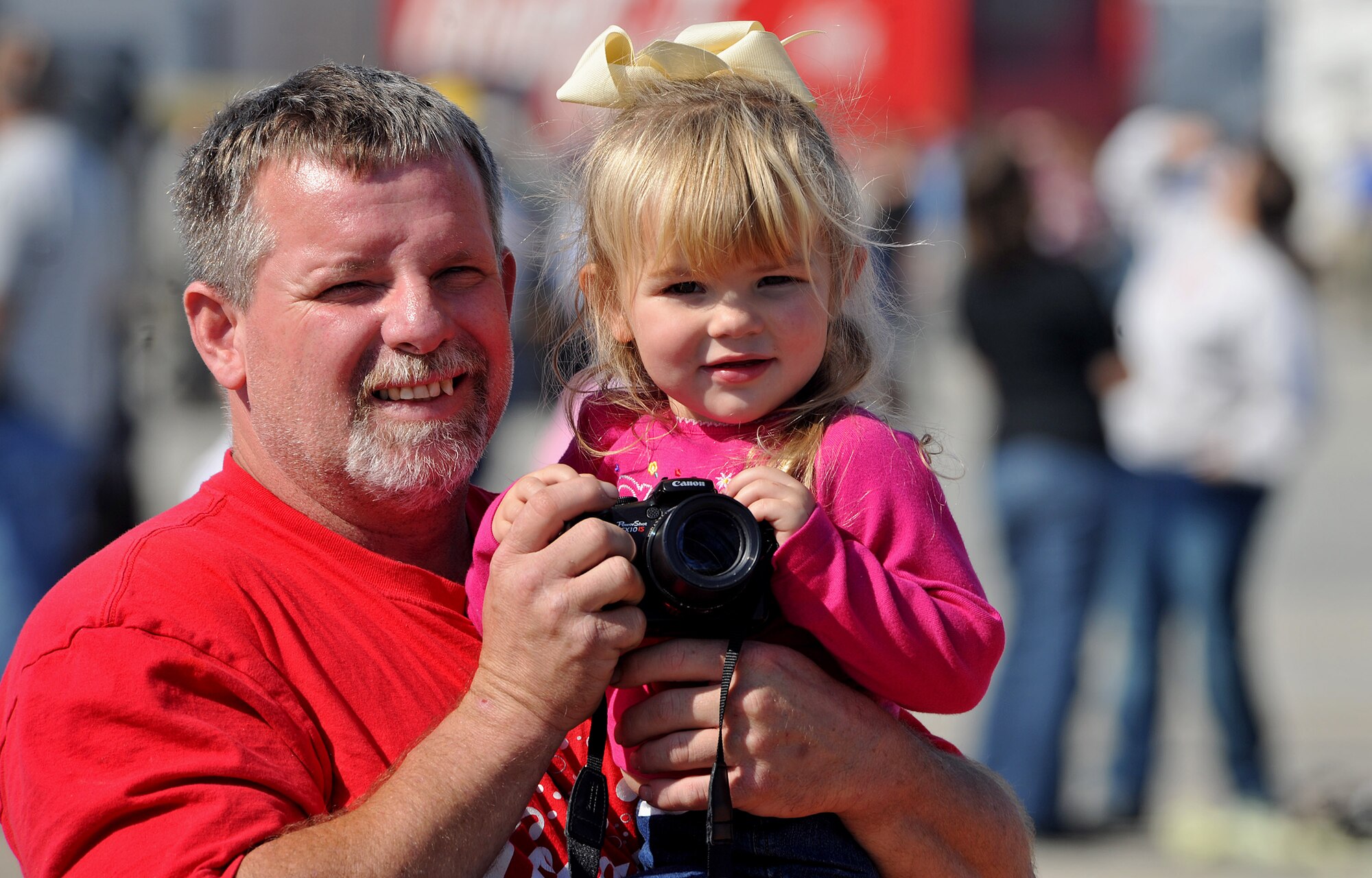 MOODY AIR FORCE BASE, Ga. -- Josh Howard, Coca-Cola driver, and his daughter Corurson Howard take photos of acts performed at the Community Appreciation Day Air Show Nov. 13. Corurson is three years old and this Air Show was her first Air Show. (U.S. Air Force photo/Airman 1st Class Joshua Green)(RELEASED)
