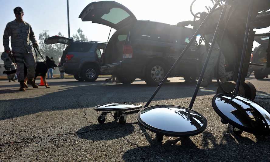 MOODY AIR FORCE BASE, Ga. -- Airmen from the 23rd Security Forces Squadron performs vehicle searches during the Community Appreciation day Air Show Nov. 13. Moody housed various performers and demonstrations from the A-10C Thunderbolt II to a P-40 Warhawk, two aircraft that fly with the historic Flying Tigers logo. (U.S. Air Force photo/Airman 1st Class Joshua Green)(RELEASED)
