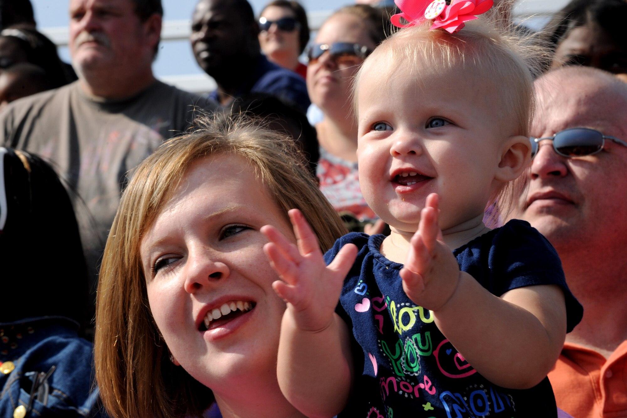 MOODY AIR FORCE BASE, Ga. -- Morgan Beckelheimer, daughter of Ryan and Sara Beckelheimer, claps her hands as members from the 93rd Air Ground Operations Wing demonstrate the capabilities of their Military Working Dogs during Moody’s Community Appreciation Day Air Show Nov. 13. This was the first air show that the Beckelheimer family has attended. (U.S. Air Force photo/Airman 1st Class Benjamin Wiseman)(RELEASED)