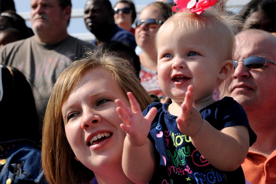 MOODY AIR FORCE BASE, Ga. -- Morgan Beckelheimer, daughter of Ryan and Sara Beckelheimer, claps her hands as members from the 93rd Air Ground Operations Wing demonstrate the capabilities of their Military Working Dogs during Moody’s Community Appreciation Day Air Show Nov. 13. This was the first air show that the Beckelheimer family has attended. (U.S. Air Force photo/Airman 1st Class Benjamin Wiseman)(RELEASED)