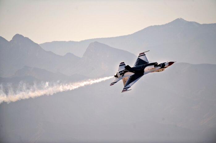 NELLIS AIR FORCE BASE, Nev. -- The United States Air Force Air Demonstration Squadron "Thunderbirds," performs a 360 degree role during the 2010 Aviation Nation Nellis Open House Nov. 12. The Nellis Open House is an opportunity for the Las Vegas community to view aerial demonstrations and static displays of various aircraft from the military. The open house also acts as the final air show of the year for the  U.S. Air Force Air Demonstration Squadron "Thunderbirds." (U.S. Air Force photo by Tech. Sgt. Michael R. Holzworth)(Released)
