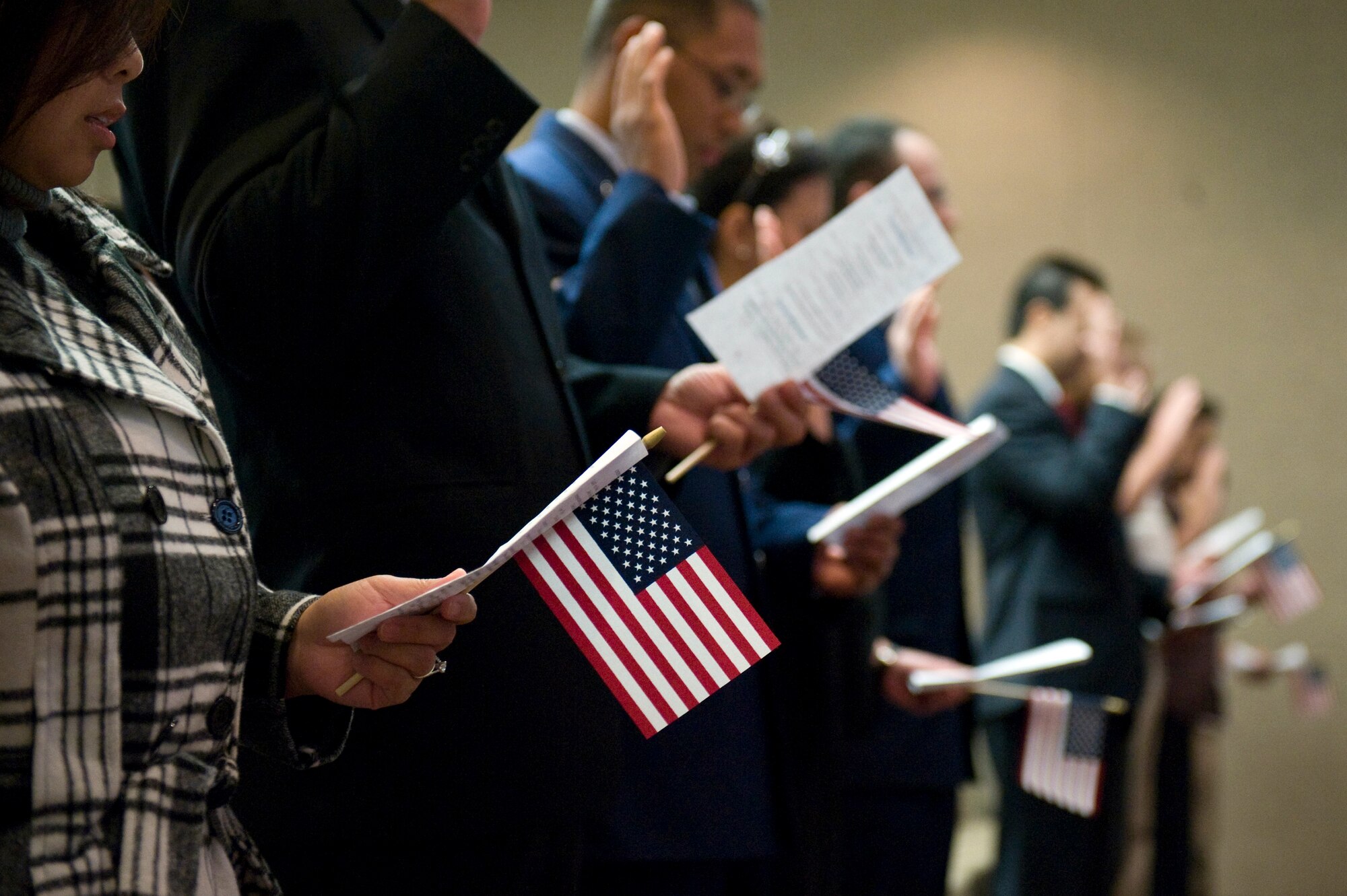 NELLIS AIR FORCE BASE, Nev.-- Members of Nellis Air Force Base and Las Vegas community recite the Oath of Allegiance during the Special Naturalization Ceremony at the Nellis Officer's Club, Nov. 12, 2010. People representing 12 different countries became United States citizens. (U.S. Air Force Photo by Airman 1st Class Jamie Nicley/Released)

