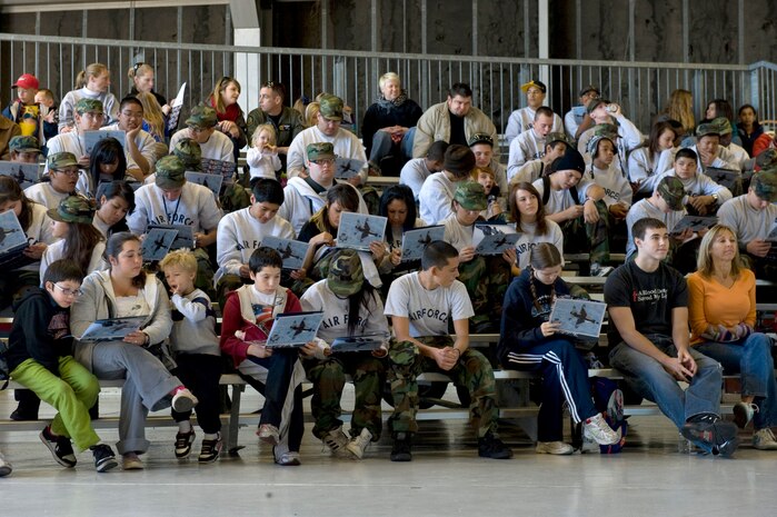 NELLIS AIR FORCE BASE, Nev.-- Las Vegas area students read through United States Air Force Air Demonstration Squadron Thunderbirds brochures during Flightline Frenzy, Nov. 12, 2010. The students and their families were invited out to Nellis to take part in the 2010 Aviation Nation Nellis Open House. (U.S. Air Force Photo by Airman 1st Class Jamie Nicley)(Released)