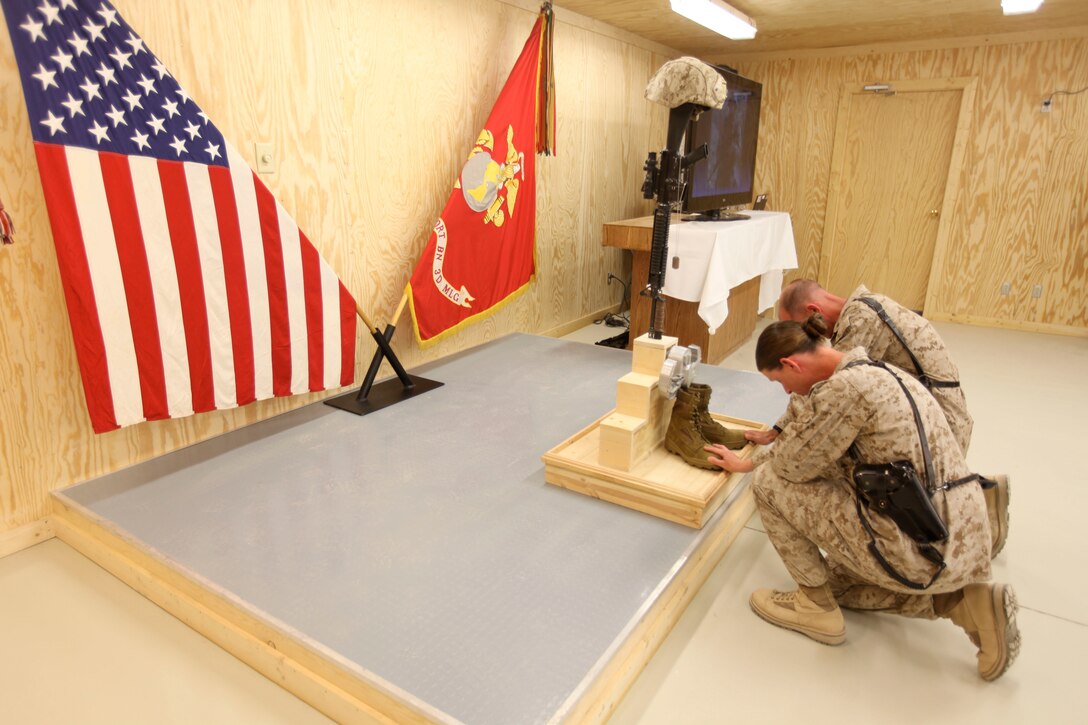 Marines pay final respects to a fallen Marine in front of a memorial display of an upturned rifle, combat boots and kevlar during Staff Sgt. Jordan Emrick’s memorial service at Camp Leatherneck, Afghanistan, Nov. 13. Emrick, an explosive ordnance disposal tech assigned to 3rd Platoon, 1st EOD Company, 1st Marine Logistics Group (Forward), was killed Nov. 5 while conducting combat operations in Helmand province, Afghanistan.