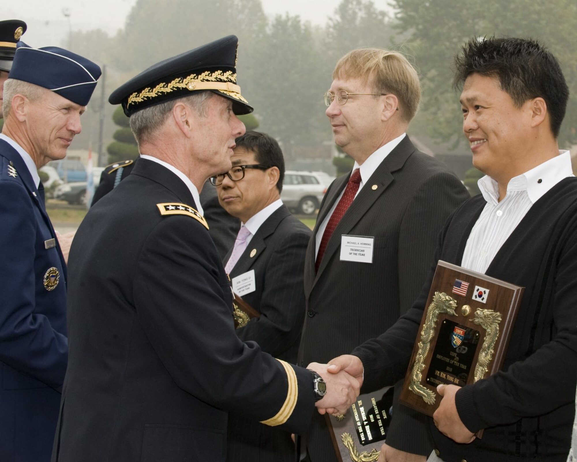 U.S. ARMY GARRISON YONGSAN, Republic of Korea -- Army Gen. Walter Sharp, U.S. Forces Korea commander, congratulates Kim Yong-Sik, 8th Civil Engineer Squadron construction inspector, on his selection as the 2010 USFK Technician of the Year for the annual USFK Civilian Employee of the Year awards. (U.S. Army photo/Sergeant First Class Francisco Alejandro)
