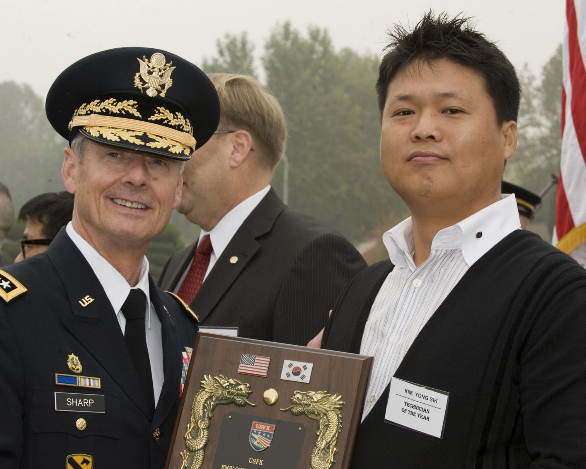 U.S. ARMY GARRISON YONGSAN, Republic of Korea -- Army Gen. Walter Sharp, U.S. Forces Korea commander, stops for a photo with Kim Yong-Sik, 8th Civil Engineer Squadron construction inspector, who was named the 2010 USFK Technician of the Year for the annual USFK Civilian Employee of the Year awards. (U.S. Army photo/Sergeant First Class Francisco Alejandro)

