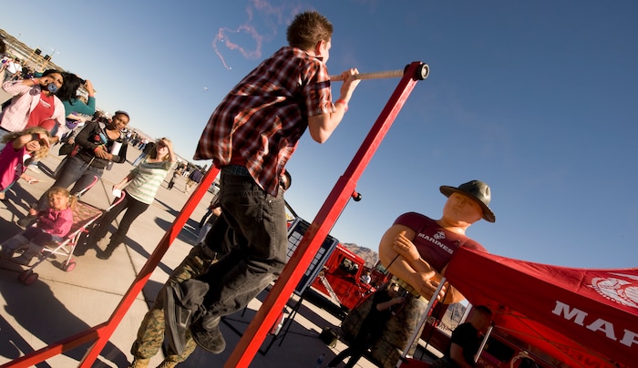 NELLIS AIR FORCE BASE, Nev.-- Nicolas Scastrunk attempts the Marine recruiting challenge by performing pull-ups during the 2010 Aviation Nation Nellis Open House Nov. 13, 2010. The Nellis Open House is an opportunity for the Las Vegas community to view aerial demonstrations and static displays of various aircraft from the military. The open house also acts as the final air show of the year for the  U.S. Air Force Air Demonstration Squadron "Thunderbirds." (U.S. Air Force photo / Senior Airman Stephanie Rubi)(Released)