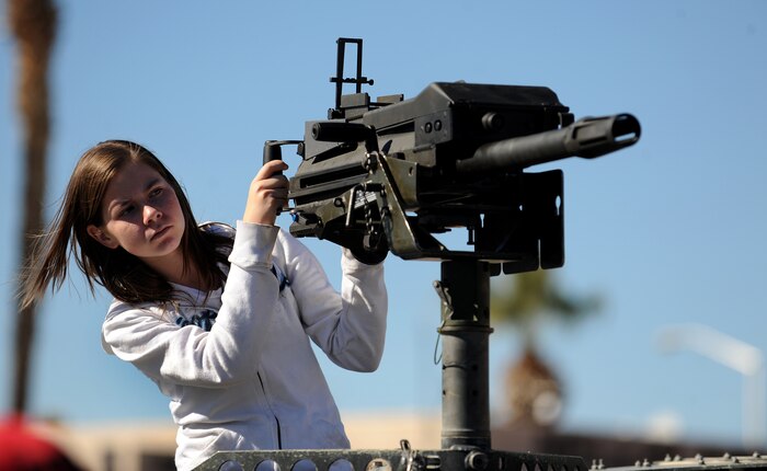 NELLIS AIR FORCE BASE, Nev. -- Kara Venners looks over a Mk19, 40mm Automatic Grenade Launcher from a top a HUMVEE at the 2010 Aviation Nation Nellis Open House Nov. 13. The Nellis Open House is an opportunity for the Las Vegas community to view aerial demonstrations and static displays of various aircraft from the military. The open house also acts as the final air show of the year for the  U.S. Air Force Air Demonstration Squadron "Thunderbirds." (U.S. Air Force photo by Senior Airman Brett Clashman/Released)