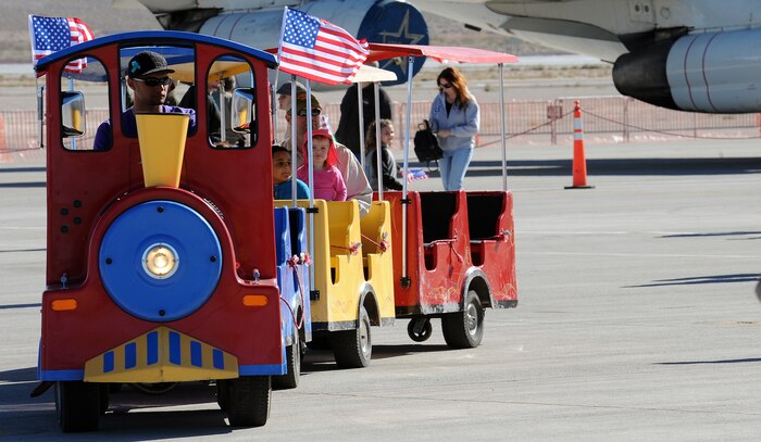 NELLIS AIR FORCE BASE, Nev. -- A trolley drives parents and chilren around the carnival area at the 2010 Aviation Nation Nellis Open House Nov. 13. The Nellis Open House is an opportunity for the Las Vegas community to view aerial demonstrations and static displays of various aircraft from the military. The open house also acts as the final air show of the year for the  U.S. Air Force Air Demonstration Squadron "Thunderbirds." (U.S. Air Force photo by Senior Airman Brett Clashman)(Released)