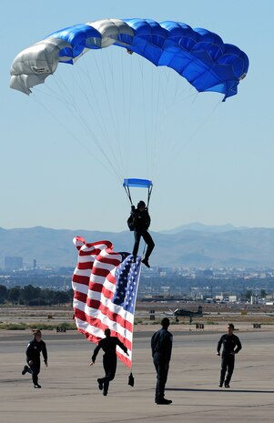 NELLIS AIR FORCE BASE, Nev. --  U.S. Air Force Academy parachute team, Wings of Blue, prepare to catch the American flag during the 2010 Aviation Nation Nellis Open House Nov. 13. The Nellis Open House is an opportunity for the Las Vegas community to view aerial demonstrations and static displays of various aircraft from the military. The open house also acts as the final air show of the year for the  U.S. Air Force Air Demonstration Squadron "Thunderbirds." (U.S. Air Force photo by Senior Airman Brett Clashman)(Released)