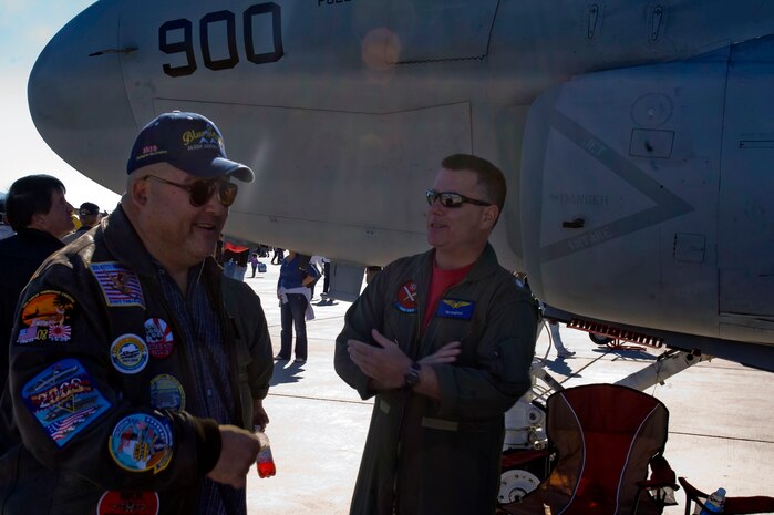NELLIS AIR FORCE BASE, Nev. --  U.S. Navy Cmdr. Tim Murphy, speaks with Howard Weitzel, a specator at the 2010 Aviation Nation Nellis Open House, Nov. 13, 2010. The Nellis Open House is an opportunity for the Las Vegas community to view aerial demonstrations and static displays of various aircraft from the military. The open house also acts as the final air show of the year for the  U.S. Air Force Air Demonstration Squadron "Thunderbirds." (U.S. Air Force Photo by Airman 1st Class Jamie Nicley/Released)                                       