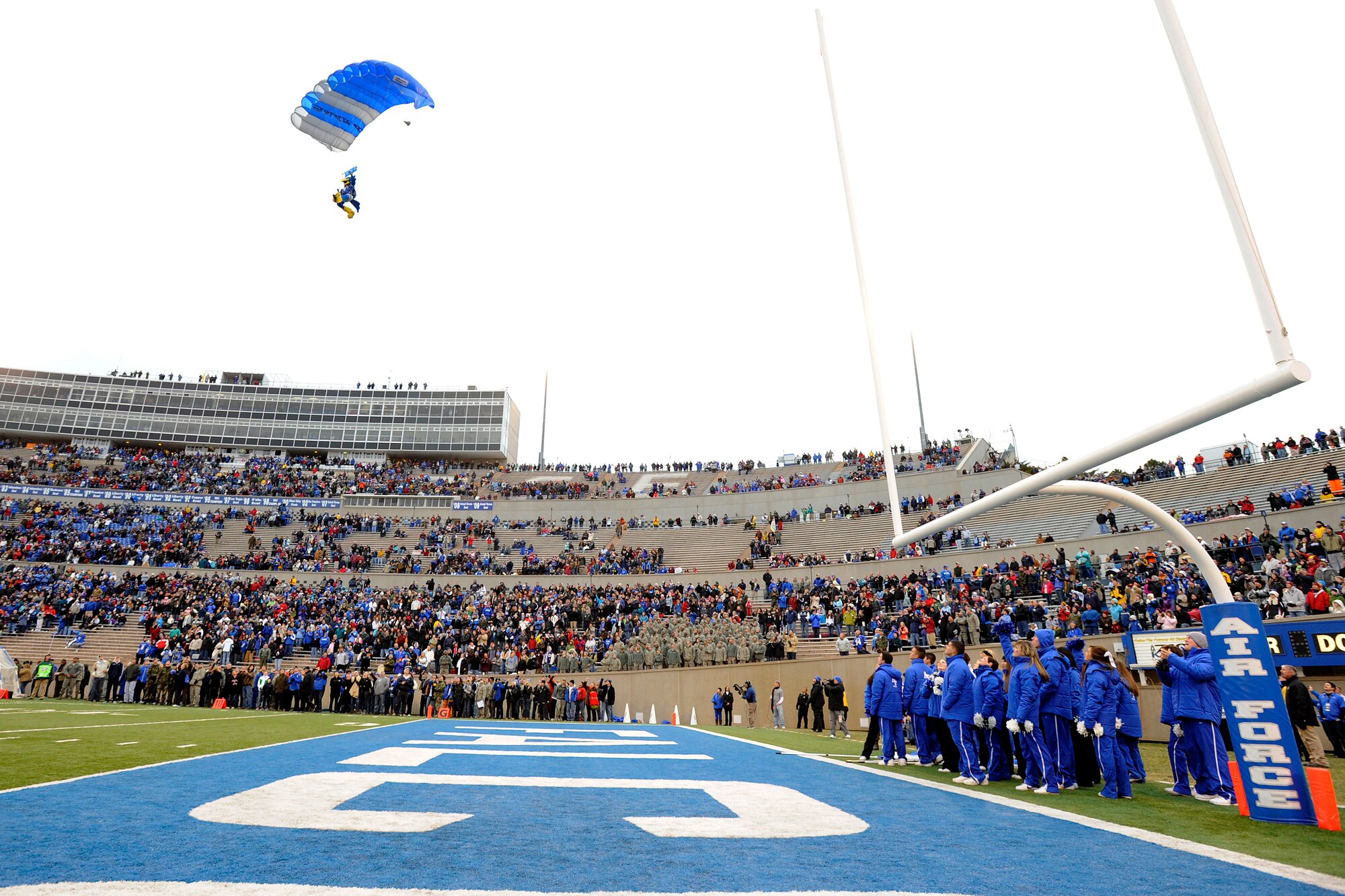 The Bird descends into Falcon Stadium in Colorado Springs, Colo., after jumping with the Wings of Blue Air Force Parachute Demonstration Team Nov. 13, 2010.  The Falcons defeated the Lobos 48-13. The Falcons, 7-4 overall and 4-3 in the Mountain West conference close out the regular season against Las Vegas Nov. 18. (U.S. Air Force photo/Mike Kaplan)