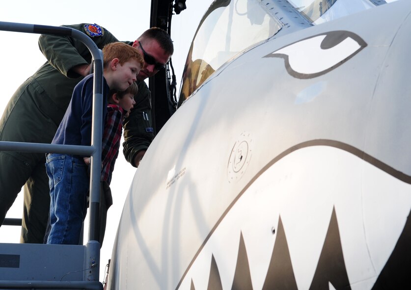 MOODY AIR FORCE BASE, Ga.-- Adrian Lindahl (front) and Reese Morton (center), sons of Justin and Penny Morton, ask Capt. Drew Voss, 74th Fighter Squadron A-10 pilot, questions about the A-10C Thunderbolt II. Thousands of people lined up to see the different types of aircraft used in present day and previous wars. (U.S. Air Force photo/Senior Airman Stephanie Longoria)(RELEASED)
