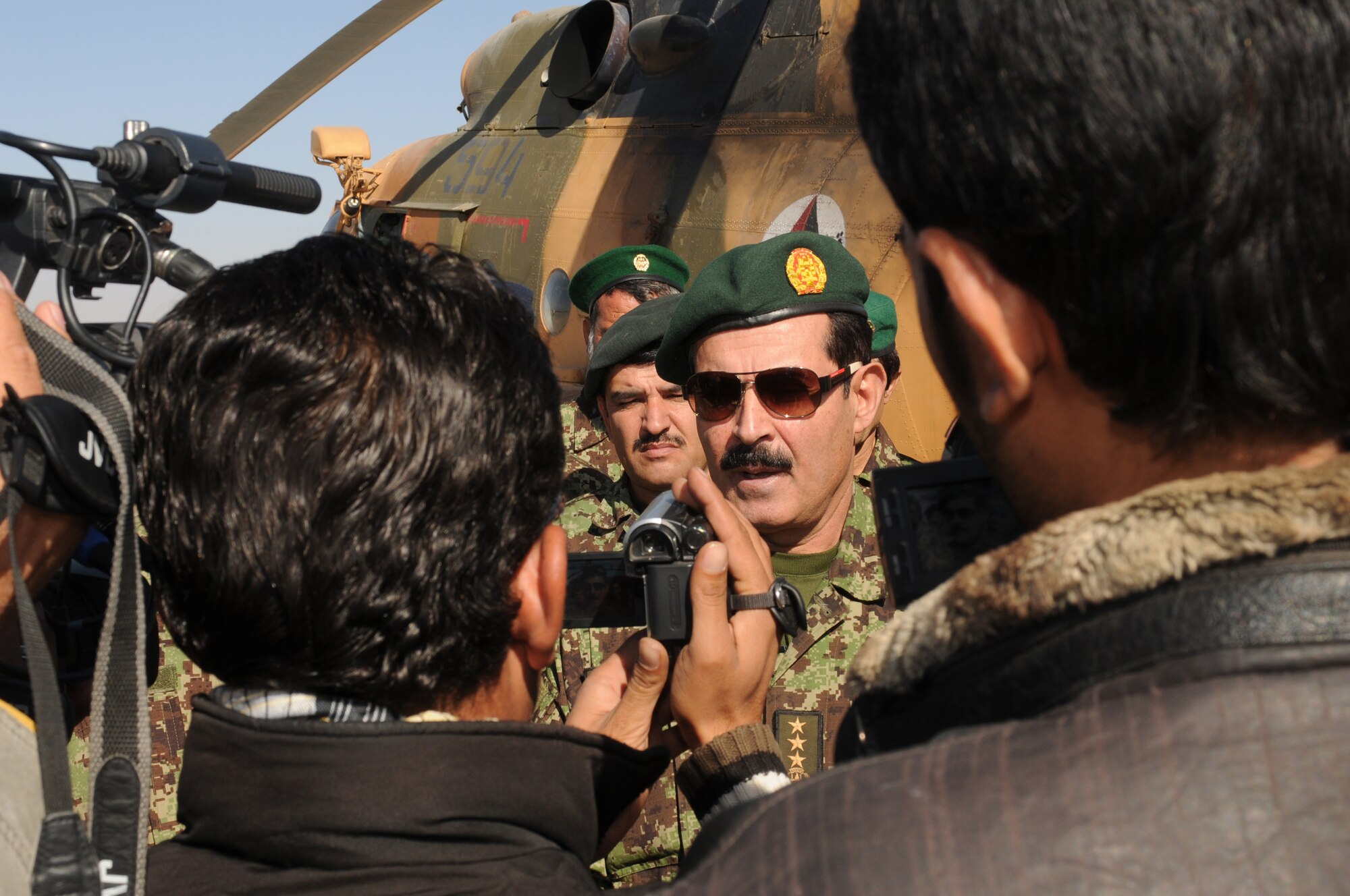 SHINDAND, Afghanistan -- Maj. Gen. Mohammad Darwan, Afghan Air Force commander, takes questions from media following a ceremony held in honor of Shindand Air Base receiving its first two aircraft: two Mi-17 helicopters Nov. 13. Shindand is scheduled to become the major training post for Afghan pilot training, with 40 aircraft set to be stationed at the base by 2015. (US Navy photo by MC2 Vladimir Potapenko/RELEASED)



