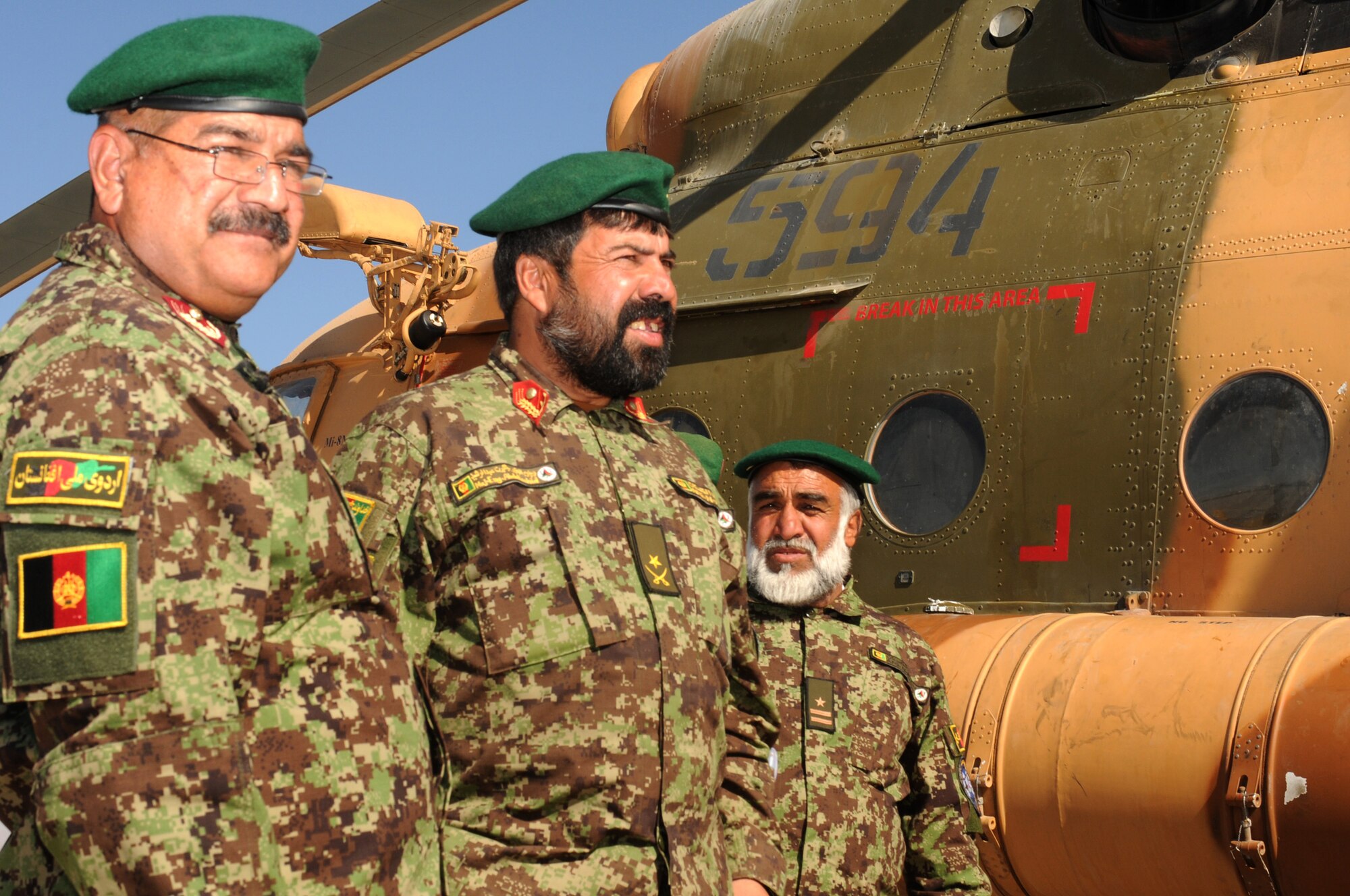 SHINDAND, Afghanistan -- Afghan officers pose in front of the first Afghan aircraft housed at Shindand Air Base Nov. 13. In all, two Mi-17 helicopters arrived in Shindand, a milestone in turning Shindand into a major pilot training base in Afghanistan. (US Navy photo by MC2 Vladimir Potapenko/RELEASED)


