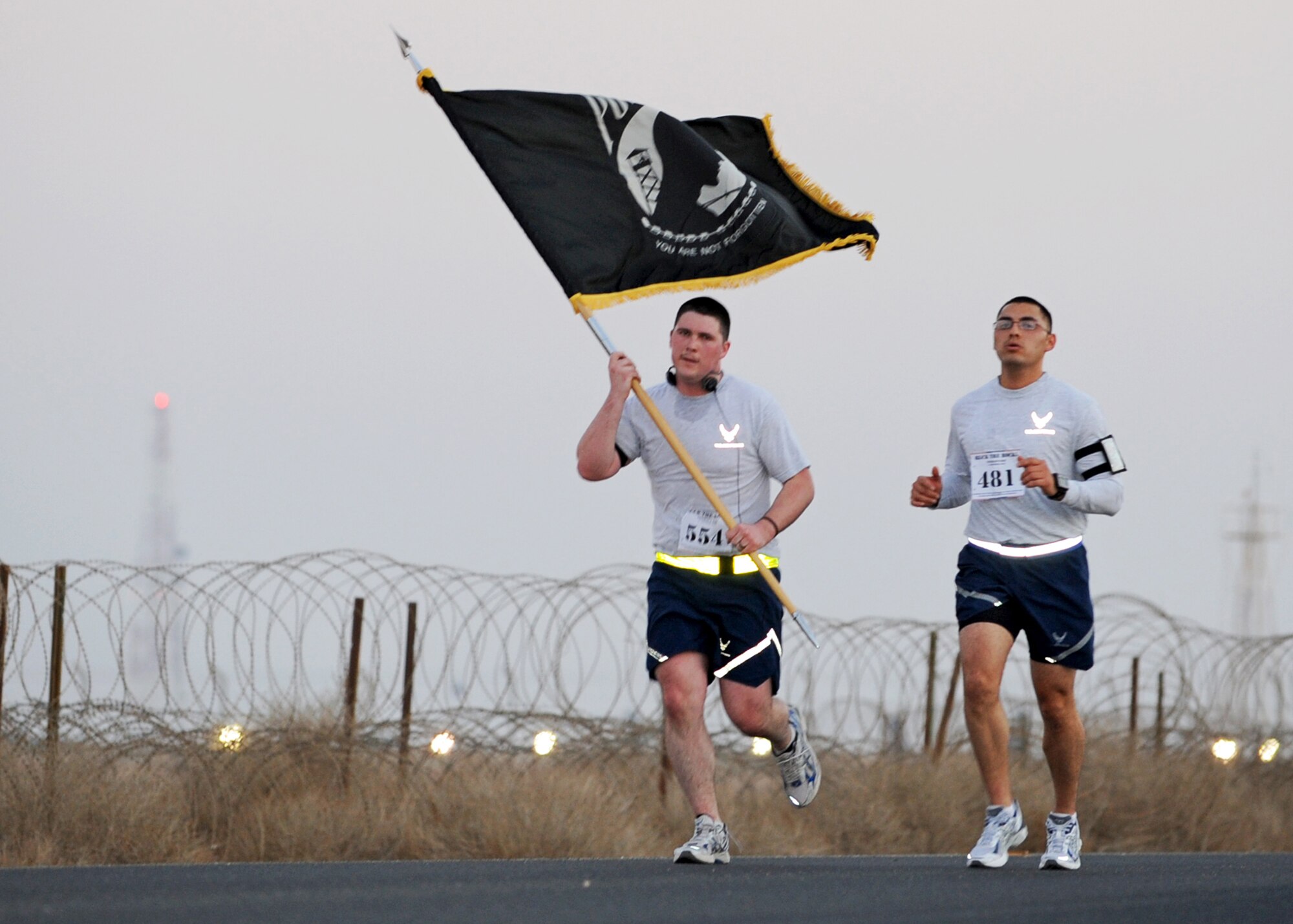 SOUTHWEST ASIA - Airmen from the 386th Air Expeditionary Wing carry the POW/MIA flag while participating in "Ruck the Rock," a 6.2-mile march honoring the service of veterans at an undisclosed airbase here Nov. 11, 2010. Teams of four completed the Veterans Day event by competing in three classes: Military Heavy (in uniform with a 30-pound ruck), Military Light (in uniform only) and PT (in physical training gear). (U.S. Air Force photo by Senior Airman Laura Turner)