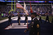 A joint service color guard marches off the field along with Marines, sailors, coast guardsmen and soldiers at the conclusion of a presume ceremony at the New York Giants military appreciation game versus the Dallas Cowboys, Nov 14.