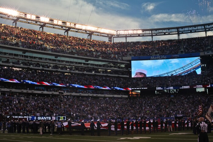 Marines, sailors, coast guardsmen and soldiers unfurl a large American flag is presented across the field at the New York Giants military appreciation game versus the Dallas Cowboys, Nov. 14.