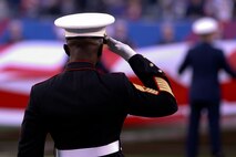Marine Sgt. Maj. Samuel Heyward Jr., recruiting command New York sergeant major, salutes as a large American flag is presented across the field at the New York Giants military appreciation game versus the Dallas Cowboys, Nov. 14