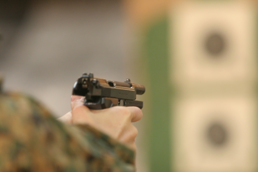 Lance Cpl. Jamie L. Anderson, Wolf- Tactical Reconnaissance and Personal Protection participant, sights in on the target during one of the many drills executed in the Wolf- T.R.A.P.P. course at the Indoor Small Arms Range here Nov. 15. One of the most important steps in achieving a well aimed shot is to focus on the front sight tip as opposed to looking staight at the target.
