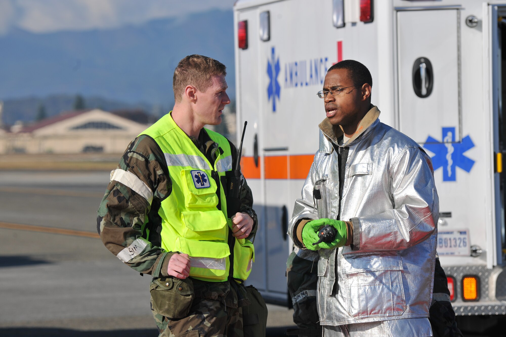 YOKOTA AIR BASE, Japan -- Captain Eric Abrames (left), 374th Aerospace Medicine Squadron, and Staff Sgt. James Waldron (right), 374th Civil Engineer Squadron, discuss the current situation during the Emergency Management Exercise here, Nov. 16. (U.S. Air Force photo/Osakabe Yasuo)