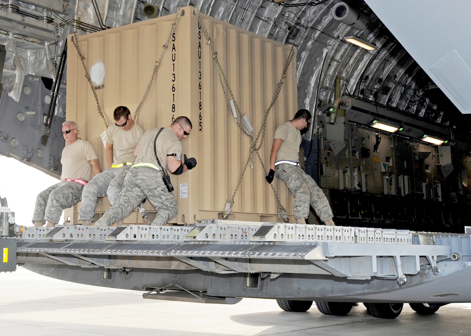 Aerial port Airmen from the 386th Expeditionary Logistics Readiness Squadron roll a pallet of cargo into a C-17 Globemaster III Nov. 3, 2010, at an air base in Southwest Asia.  The Airmen inspect and palletize all cargo before shipment. They also work closely with aircraft loadmasters to carefully position the cargo inside aircraft. (U.S. Air Force photo/Senior Airman Laura Turner)