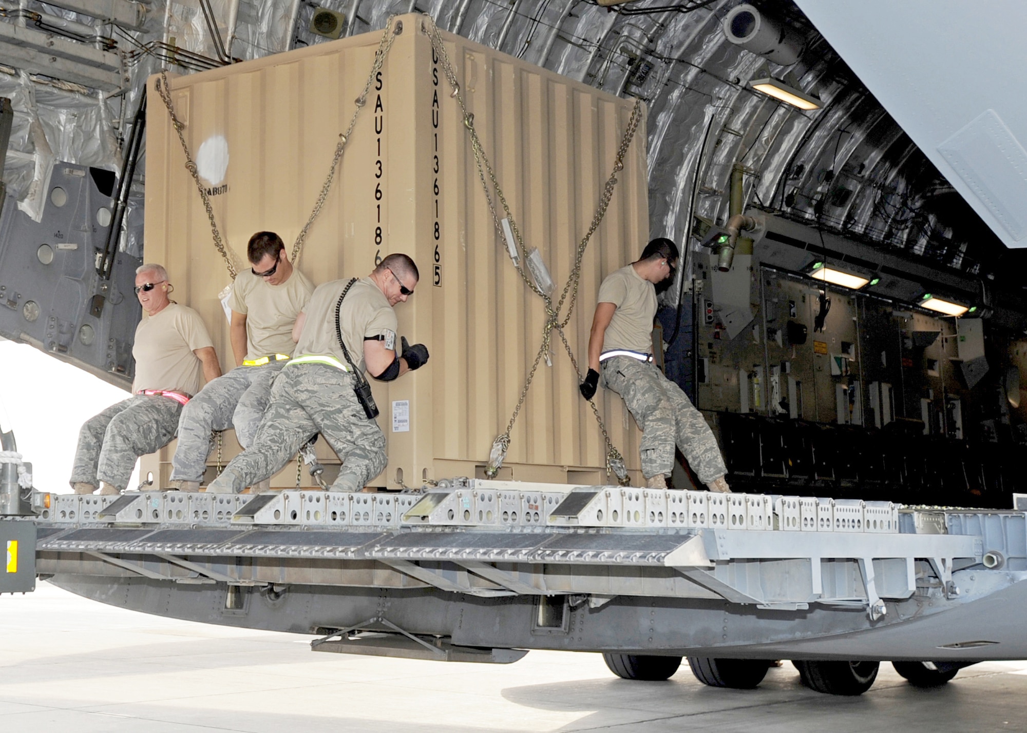 Aerial port Airmen from the 386th Expeditionary Logistics Readiness Squadron roll a pallet of cargo into a C-17 Globemaster III Nov. 3, 2010, at an air base in Southwest Asia.  The Airmen inspect and palletize all cargo before shipment. They also work closely with aircraft loadmasters to carefully position the cargo inside aircraft. (U.S. Air Force photo/Senior Airman Laura Turner)