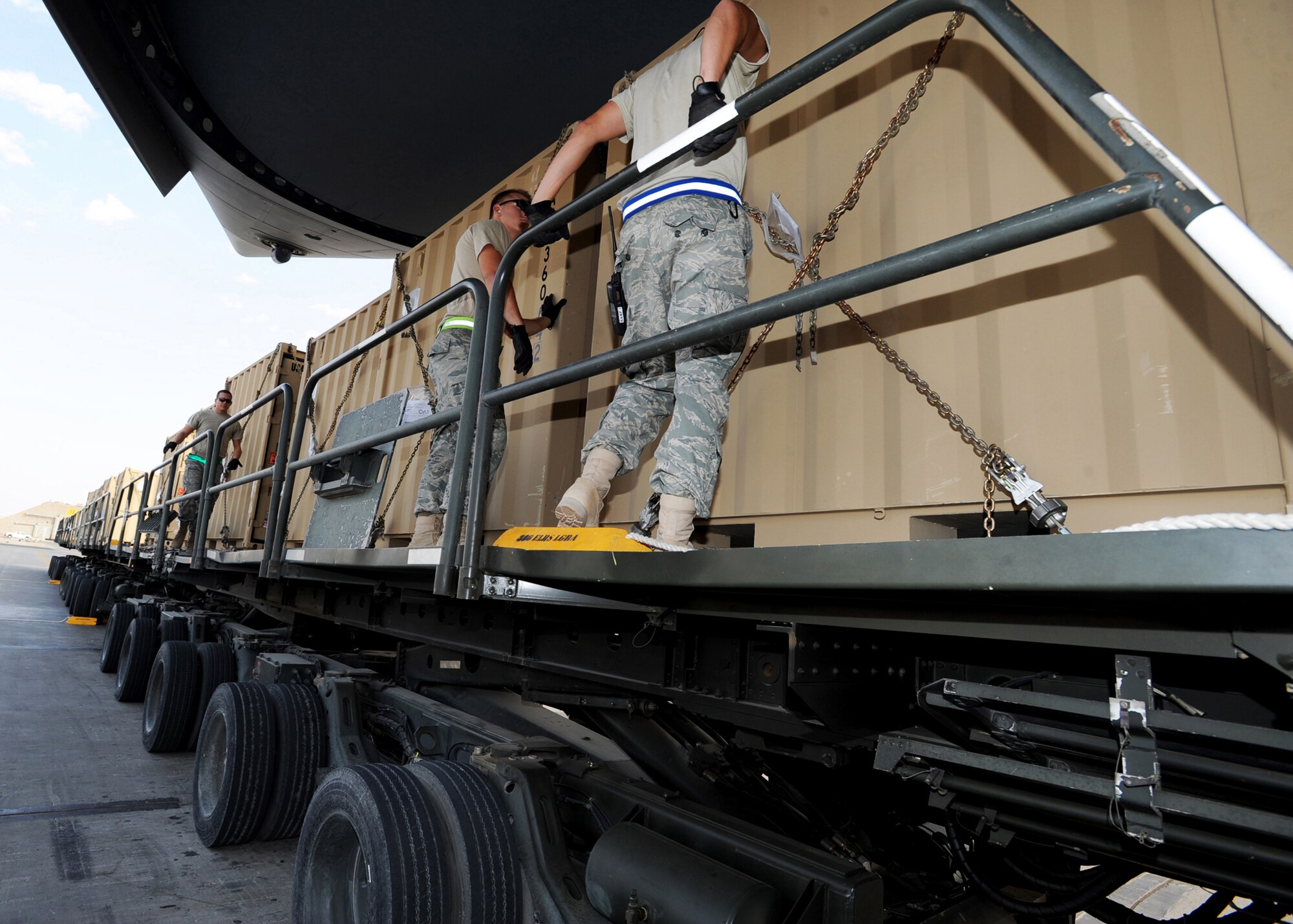 Aerial port Airmen from the 386th Expeditionary Logistics Readiness Squadron prepare to push pallets of cargo off a K-loader onto a waiting C-17 Globemaster III Nov. 3, 2010, at an air base in Southwest Asia.  A K-loader is a specialized flat-bed truck designed to carry pallets of cargo from a marshalling yard to waiting aircraft. The K-loader's bed can be raised, lowered or pitched in different directions so that it mates perfectly with the cargo bay of any airlifter. The bed also is fitted with a roller system that allows Airmen to push pallets weighing up to 7,000 pounds off the truck and onto aircraft with ease. (U.S. Air Force photo/Senior Airman Laura Turner)