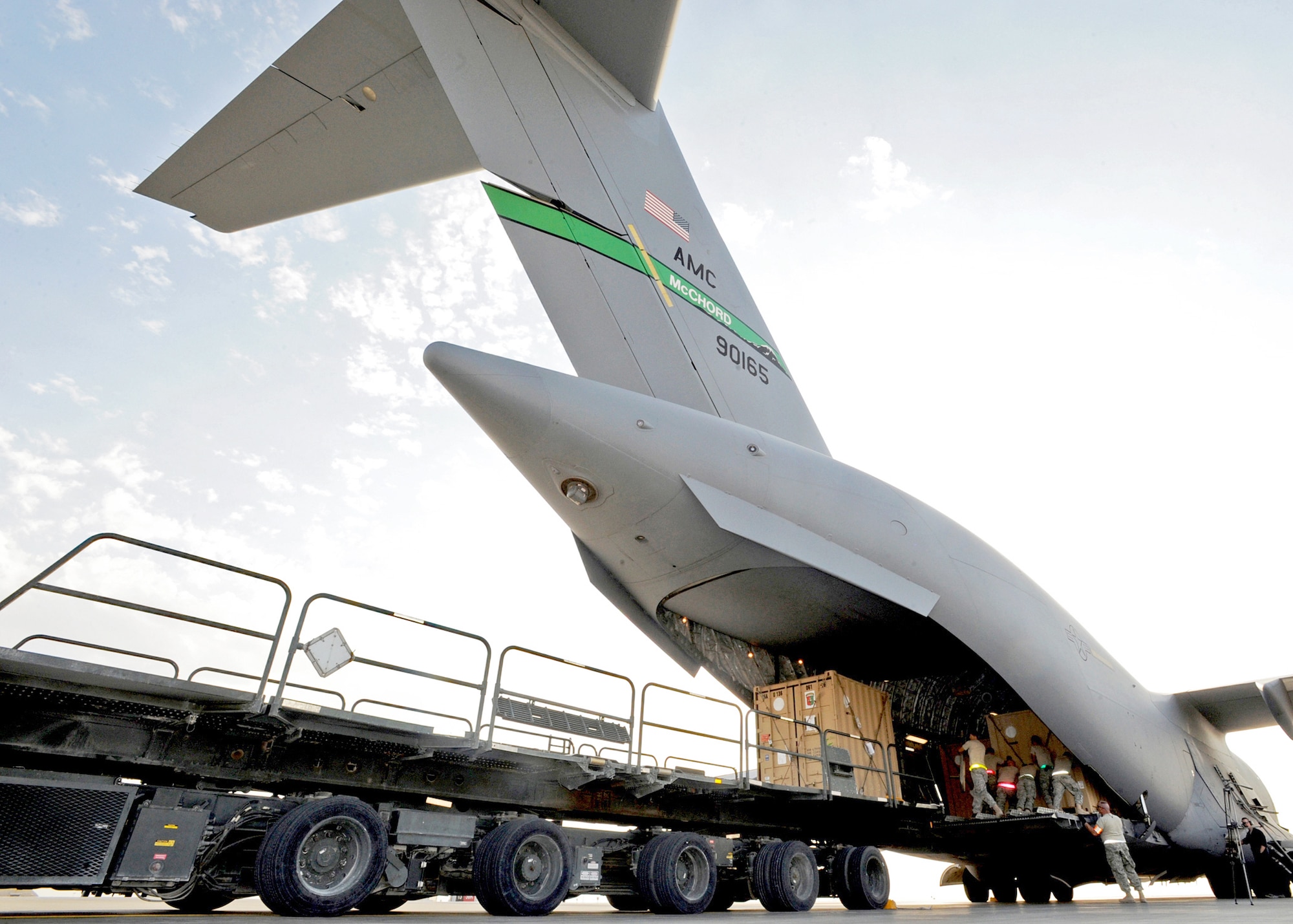Aerial port Airmen from the 386th Expeditionary Logistics Readiness Squadron use a K-loader to move pallets of cargo onto a C-17 Globemaster III Nov. 3, 2010, at an air base in Southwest Asia.  A K-loader is a specialized flat-bed truck designed to carry pallets of cargo from a marshalling yard to waiting aircraft. The K-loader's bed can be raised, lowered or pitched in different directions so that it mates perfectly with the cargo bay of any airlifter. The bed also is fitted with a roller system that allows Airmen to push pallets weighing up to 7,000 pounds off the truck and onto aircraft with ease. (U.S. Air Force photo/Senior Airman Laura Turner)