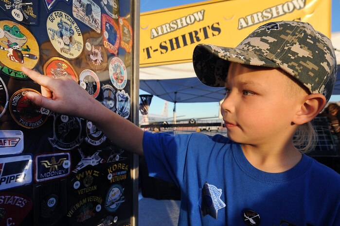 NELLIS AIR FORCE BASE, Nev.--  Cordell Cornell points out his favorite patch during the 2010 Aviation Nation Nellis Open House Nov. 14. The Nellis Open House is an opportunity for the Las Vegas community to view aerial demonstrations and static displays of various aircraft from the military. The open house also acts as the final air show of the year for the U.S. Air Force Air Demonstration Squadron, "Thunderbirds." (U.S Air Force Photo / Senior Airman Stephanie Rubi) (Released)