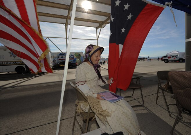 NELLIS AIR FORCE BASE, Nev.-- Lisa Coffey from the Southern Nevada Living History Association takes a break from the festivities on Nov. 14, 2010 during Aviation Nation, Nellis Air Force Base Open House and annual Las Vegas air show.  The two-day event also depicts the history of American aviation and salutes the recent accomplishments of America's military in operations around the globe through numerous additional military and civilian ground displays. (U.S. Air Force photo/ Master Sgt. Kevin J. Gruenwald) released