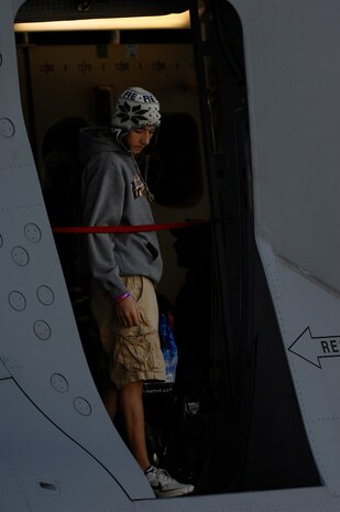 NELLIS AIR FORCE BASE, Nev.--Las Vegas resident Enrique Vasquez peers out the door of a C-17 Globemaster III Nov. 14, 2010 during Aviation Nation, Nellis Air Force Base Open House and annual Las Vegas air show.  The two-day event also depicts the history of American aviation and salutes the recent accomplishments of America's military in operations around the globe through numerous additional military and civilian ground displays. (U.S. Air Force photo/ Master Sgt. Kevin J. Gruenwald) released