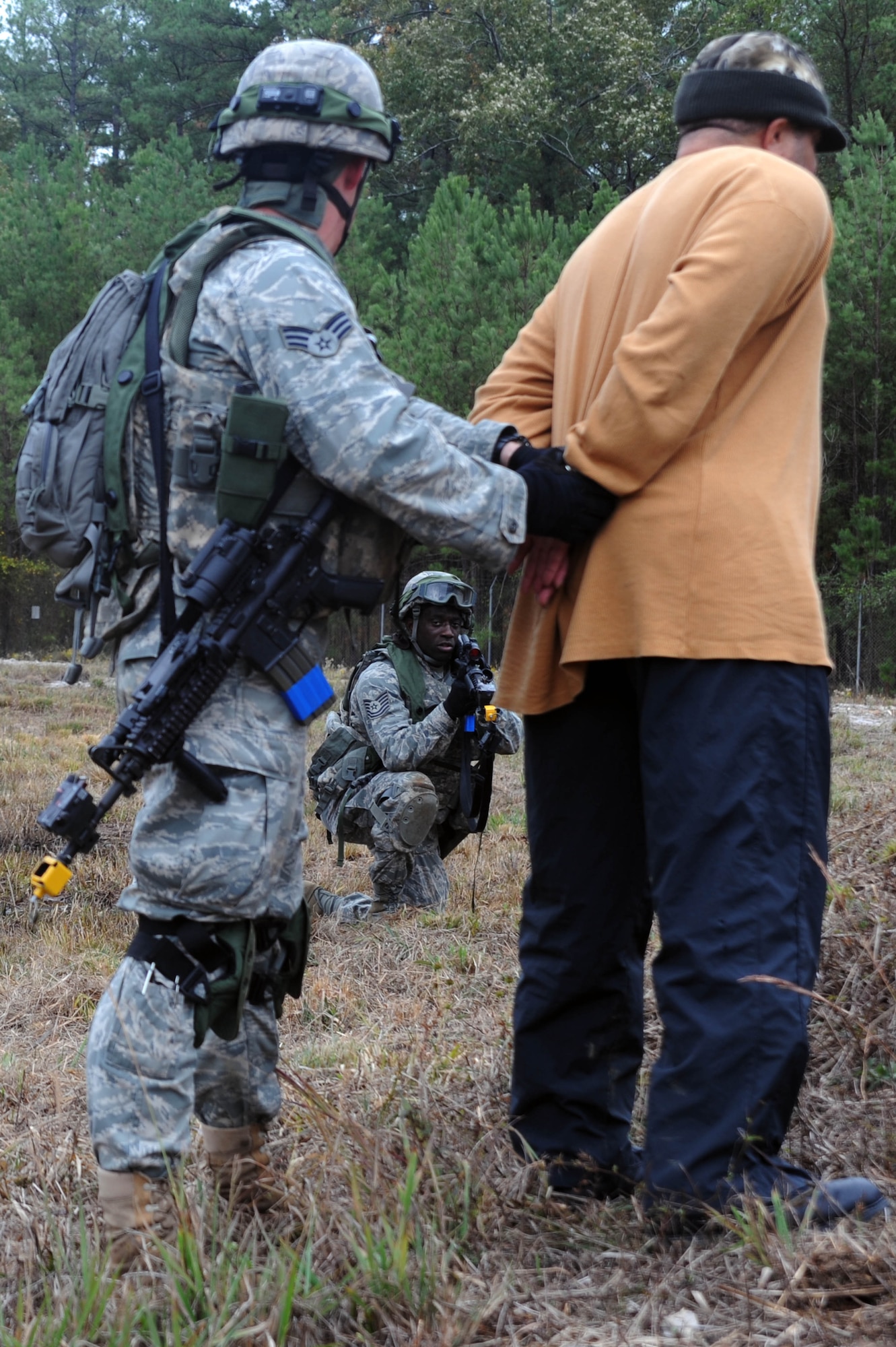 Senior Airman Sean Phelan, 2nd Security Forces Squadron, game warden from Barksdale Air Force Base, La., detains a scenario role player during the tactics portion of the Global Strike Challenge at Camp Minden, La., Nov. 13.The Competition includes security forces along with missile and bomber forces from Air Force Global Strike Command. Teams have the opportunity to participate in innovative thinking, teamwork and esprit de corps that are central to the GSC mission. (U.S. Air Force photo/Senior Airman Brittany Y. Bateman)(RELEASED)