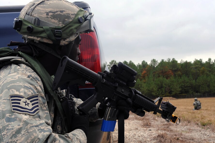 Tech. Sgt. Shawn Elmore, 2nd Security Forces Squadron, NCO in charge of pass and identification from Barksdale Air Force Base La., covers  Senior Airman Sean Phelan, 2 SFS game warden during the tactics portion of the Global Strike Challenge at Camp Minden, La., Nov. 13. The Competition includes security forces along with missile and bomber forces. Teams will have the opportunity to display their innovative thinking, teamwork and esprit de corps that are central to the GSC mission. (U.S. Air Force photo/Senior Airman Brittany Y. Bateman)(RELEASED)