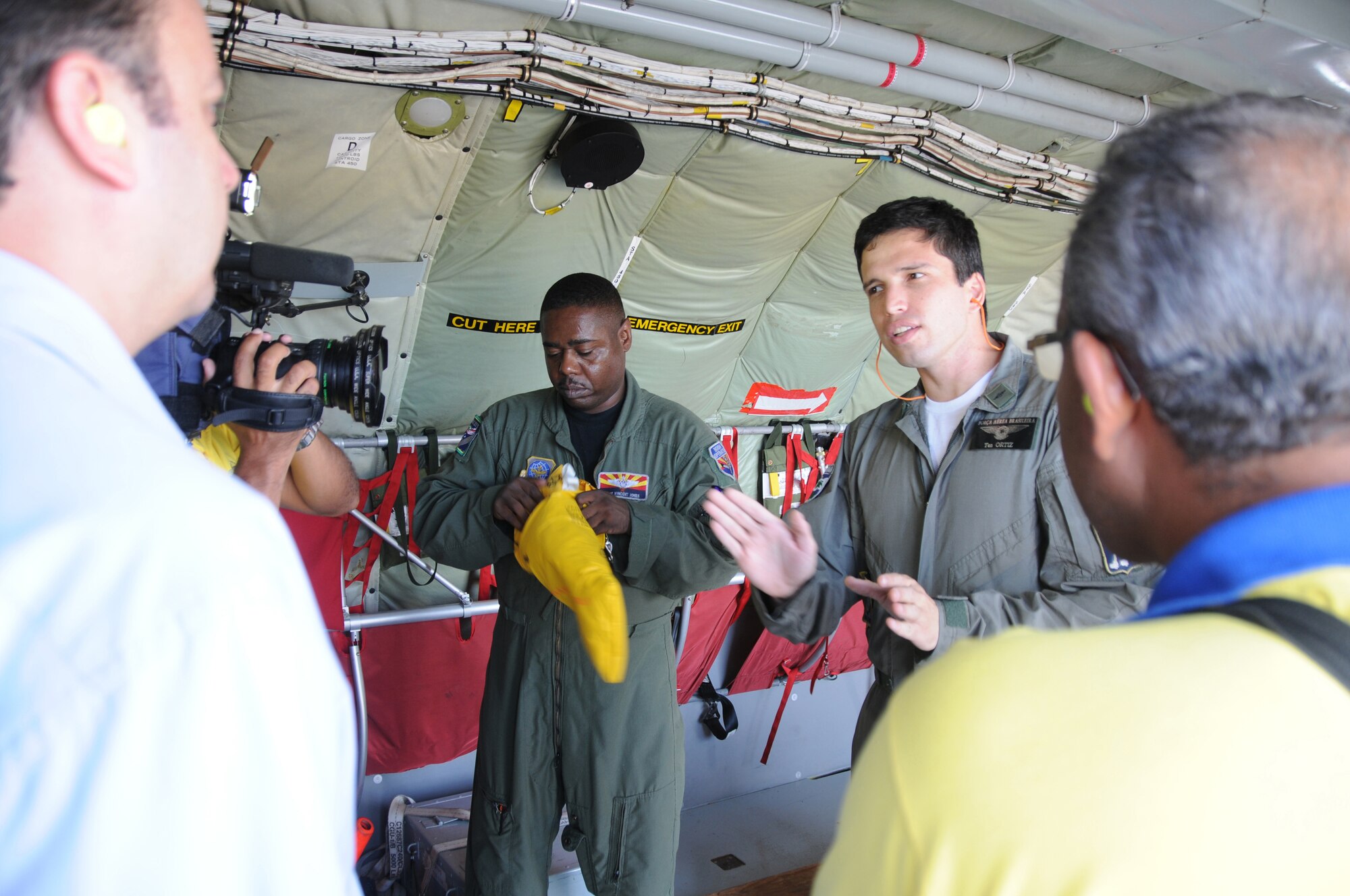 RECIFE, Brazil ? Master Sgt Vince Jones,  a boom operator for the 161st Air Refueling Wing, Phoenix Ariz., and LT Ortiz, a pilot for the Brazilian Air Force, give a safety briefing to a local media crew before a refueling mission on November 9, 2010. The 161st ARW is participating in CRUZEX V, or Cruzeiro Do Sul (Southern Cross).  CRUZEX  is a multi-national combined exercise involving the Air Forces of Argentina, Brazil, Chile, France and Uruguay, and observers from numerous other countries with more than 82 aircraft and almost 3,000 Airmen involved. U.S. Air Force Photo by Master Sgt. Kelly M. Deitloff