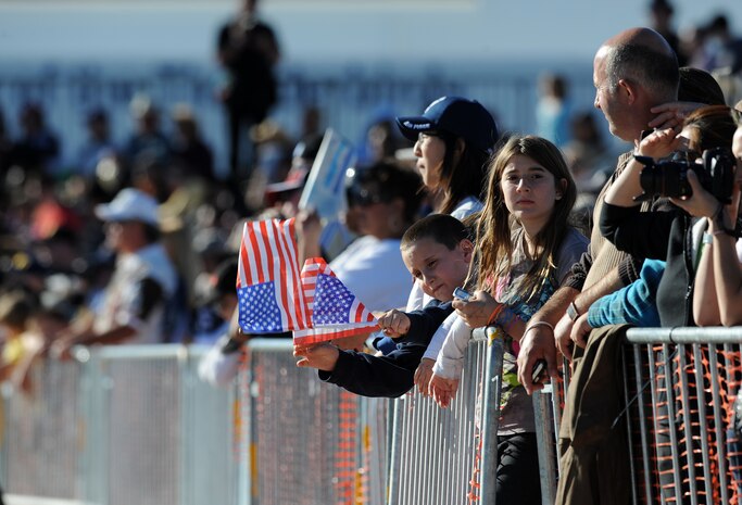 NELLIS AIR FORCE BASE, Nev. -- A child waves the American flags during the 2010 Aviation Nation Nellis Open House Nov. 14. The Nellis Open House is an opportunity for the Las Vegas community to view aerial demonstrations and static displays of various aircraft from the military. The open house also acts as the final air show of the year for the U.S. Air Force Air Demonstration Squadron, "Thunderbirds." (U.S. Air Force photo by Senior Airman Brett Clashman)(Released)