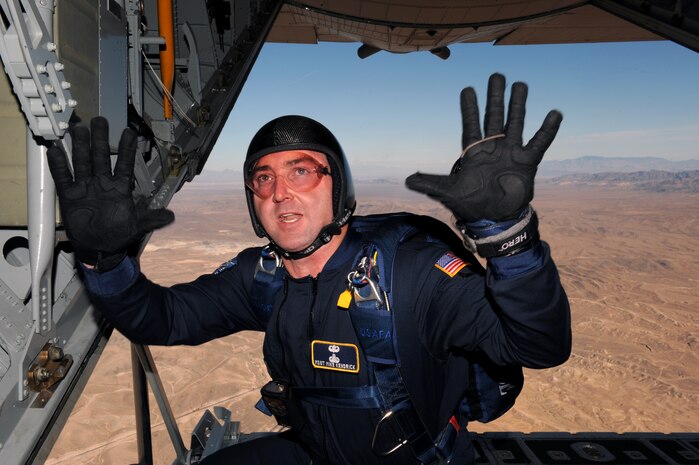 NELLIS AIR FORCE BASE, Nev. -- Master Sgt. Mike Kendrick with the  U.S. Air Force Academy parachute team, Wings of Blue, informs his team they are ten minutes until jump time out of a C-130 Hercules during the 2010 Aviation Nation Nellis Open House Nov. 14. The Nellis Open House is an opportunity for the Las Vegas community to view aerial demonstrations and static displays of various aircraft from the military. The open house also acts as the final air show of the year for the U.S. Air Force Air Demonstration Squadron, "Thunderbirds." (U.S. Air Force photo by Senior Airman Brett Clashman)(Released)