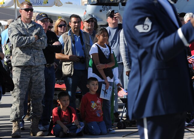 NELLIS AIR FORCE BASE, Nev.-- Spectators watch the U.S. Air Force Honor Guard Drill team from Bolling Air Force base Washington D.C. perform at 2010 Aviation Nation Nellis Open House Nov. 14. The Open House is an opportunity for the Las Vegas community to view aerial demonstrations and static displays of various aircraft from the military. The open house also acts as the final air show of the year for the U.S. Air Force Air Demonstration Squadron, "Thunderbirds." (U.S Air Force Photo / Airman 1st Class Matthew Lancaster) (Released)