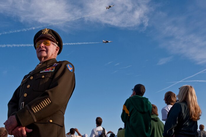 NELLIS AIR FORCE BASE, Nev. --   World War II, Korean War, and Vietnam Fighter Pilot U.S. Air Force Retired Maj.Dick Wyatt poses for a photo as the U.S. Air Force Air Demonstration Squadron, "Thunderbirds," perform at the 2010 Aviation Nation Nellis Open House Nov. 14.  The Nellis Open House is an opportunity for the Las Vegas community to view aerial demonstrations and static displays of various aircraft from the military. The open house also acts as the final air show of the year for the  U.S. Air Force Air Demonstration Squadron "Thunderbirds." (U.S. Air Force photo by Tech. Sgt. Michael R. Holzworth)(Released)