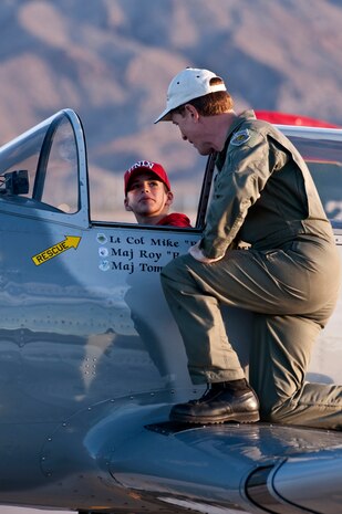 NELLIS AIR FORCE BASE, Nev. --  U.S. Air Force Retired Lt. Col. Mike Carter shows Jacob Cornish the cockpit of a 1983 Nanchang CJ-6A during the 2010 Aviation Nation Nellis Open House Nov. 14.The Nellis Open House is an opportunity for the Las Vegas community to view aerial demonstrations and static displays of various aircraft from the military. The open house also acts as the final air show of the year for the  U.S. Air Force Air Demonstration Squadron "Thunderbirds." (U.S. Air Force photo by Tech. Sgt. Michael R. Holzworth)(Released)