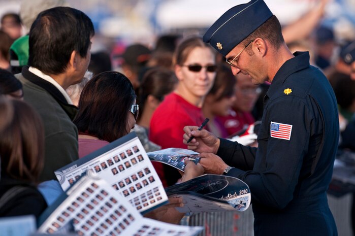 NELLIS AIR FORCE BASE, Nev. --   Maj. David Lemery U.S. Air Force Air Demonstration Squadron "Thunderbirds,"  maintenance officersigns autographs during the 2010 Aviation Nation Nellis Open House Nov. 14. The Nellis Open House is an opportunity for the Las Vegas community to view aerial demonstrations and static displays of various aircraft from the military. The open house also acts as the final air show of the year for the U.S. Air Force Air Demonstration Squadron "Thunderbirds." (U.S. Air Force photo by Tech. Sgt. Michael R. Holzworth)(Released)