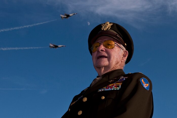 NELLIS AIR FORCE BASE, Nev. --   World War II, Korean War, and Vietnam Fighter Pilot U.S. Air Force Retired Maj.Dick Wyatt poses for a photo as the U.S. Air Force Air Demonstration Squadron, "Thunderbirds" perform at the 2010 Aviation Nation Nellis Open House Nov. 14.  The Nellis Open House is an opportunity for the Las Vegas community to view aerial demonstrations and static displays of various aircraft from the military. The open house also acts as the final air show of the year for the  U.S. Air Force Air Demonstration Squadron "Thunderbirds." (U.S. Air Force photo by Tech. Sgt. Michael R. Holzworth)(Released)