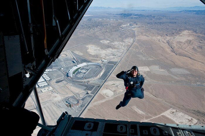 NELLIS AIR FORCE BASE, Nev. --  U.S. Air Force Academy Cadet 1st Class Alan Wong with the  U.S. Air Force Academy parachute team, Wings of Blue, salutes as he exits the back of a C-130 Hercules during the 2010 Aviation Nation Nellis Open House Nov. 14. Cadet 1st Class Wong jumped with an American Flag and landed at show center during the playing of the national anthem to open the final day of the open house. The Nellis Open House is an opportunity for the Las Vegas community to view aerial demonstrations and static displays of various aircraft from the military. The open house also acts as the final air show of the year for the  U.S. Air Force Air Demonstration Squadron "Thunderbirds." (U.S. Air Force photo by Tech. Sgt. Michael R. Holzworth)(Released)