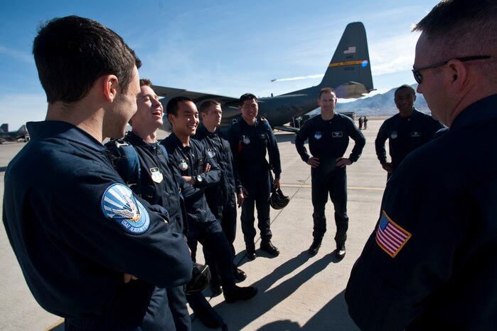 NELLIS AIR FORCE BASE, Nev. -- The  U.S. Air Force Academy parachute team Wings of Blue, share a laugh and conduct a mission brief before boarding a C-130 Hercules to perform their sky diving demonstration during the 2010 Aviation Nation Nellis Open House Nov. 14.during the 2010 Aviation Nation Nellis Open House Nov. 14. The Nellis Open House is an opportunity for the Las Vegas community to view aerial demonstrations and static displays of various aircraft from the military. The open house also acts as the final air show of the year for the U.S. Air Force Air Demonstration Squadron "Thunderbirds." (U.S. Air Force photo by Tech. Sgt. Michael R. Holzworth)(Released)