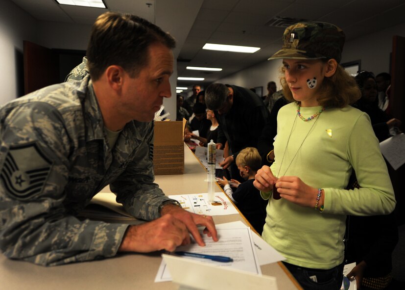 Master Sgt. James Conger briefs Lydia Givens on the importance of securing financial and physical assets before deploying during the Children's Deployment Line Nov. 13, 2010, on Joint Base Charleston, S.C. Sergeant Conger is the superintendent of the 628th Air Base Wing Legal Office. Lydia is the daughter of Lt. Col. Howard Givens, commander of the 628th Medical Operations Squadron. (U.S. Air Force photo/Senior Airman Timothy Taylor)