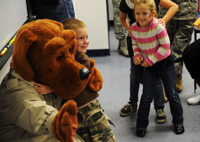 Andrew Hitefield poses for a photo with McGruff the Crime Dog at the Children's Deployment Line Nov. 13, 2010, on Joint Base Charleston, S.C. The Children's Deployment Line is a program developed to help show children what their parents go through before they deploy downrange with a little bit of added fun. Andrew is the 5-year-old son of Staff Sgt. Jacob Hitefield, who is a loadmaster with the 14th Airlift Squadron. (U.S. Air Force photo/Senior Airman Timothy Taylor)
