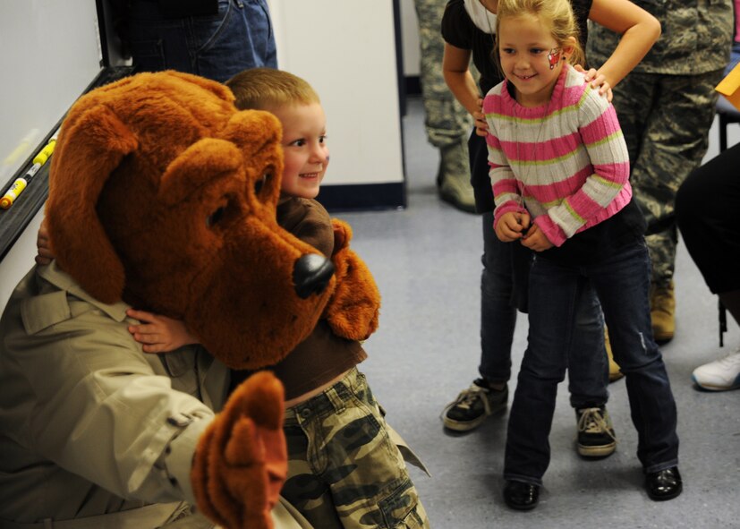 Andrew Hitefield poses for a photo with McGruff the Crime Dog at the Children's Deployment Line Nov. 13, 2010, on Joint Base Charleston, S.C. The Children's Deployment Line is a program developed to help show children what their parents go through before they deploy downrange with a little bit of added fun. Andrew is the 5-year-old son of Staff Sgt. Jacob Hitefield, who is a loadmaster with the 14th Airlift Squadron. (U.S. Air Force photo/Senior Airman Timothy Taylor)