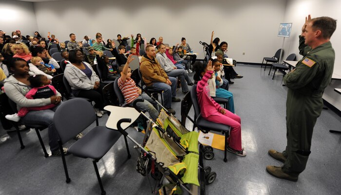 Col. John Wood briefs children and family members participating in the Children's Deployment Line as he would deploying Airmen Nov. 13, 2010, on Joint Base Charleston, S.C. The Children's Deployment Line consisted of face painting, briefings, picking up combat gear, touring a C-17 and finally eating simulated Meals, Ready-to-Eat (MREs) for lunch. Colonel Wood is the commander of the 437th Airlift Wing. (U.S. Air Force photo/Senior Airman Timothy Taylor)